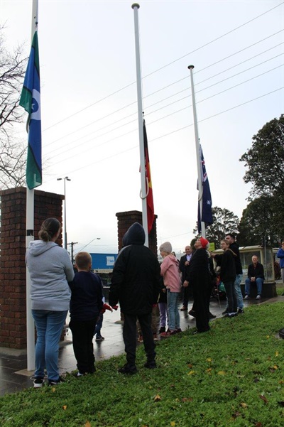 Raising the Torres Strait Islander, Aboriginal and Australian Flags in celebration of NAIDOC Week at Drouin's Memorial Park.