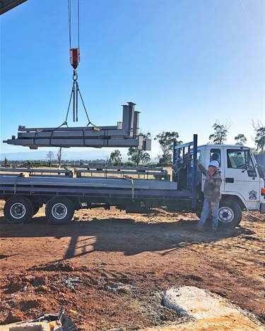 Trucks and machinery have arrived on site with the steel framing materials.