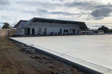 June 2022 - Framing and roofing of the pavilion are complete, cladding is underway. Ancillary works are also underway around the netball courts.