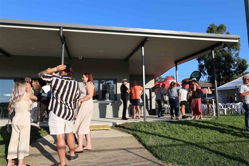 Community members mingling in front of the refurbished Balmoral Park Pavilion.