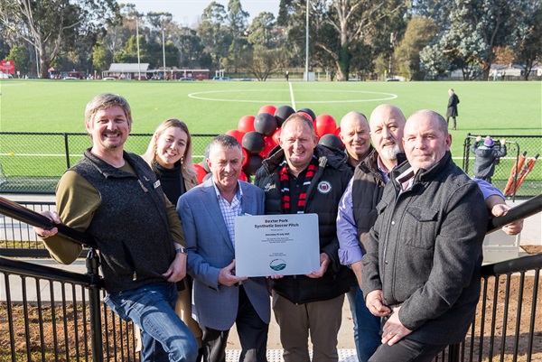 Cr Leaney, Cr Tauru, Cr Goss, Warragul United President Peter O'Dea, Mark Leighton of A1 Civil, Cr Wallace and Cr Gauci pose pitch-side with Baxter Park Opening plaque.