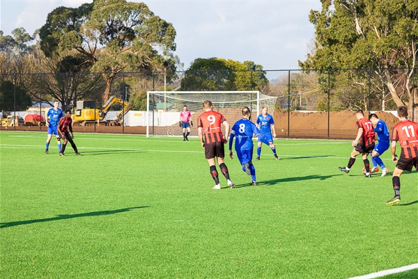 Warragul United in action against Eltham Red Backs on the newly opened synthetic pitch at Baxter Park.