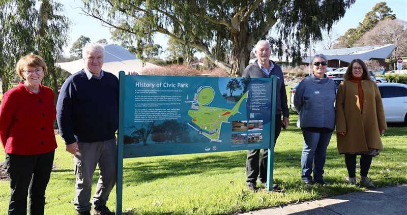 Judy Farmer, Cr Keith Cook, Cr Peter Kostos, Mayor Annemarie McCabe, and Helen Timbury with History of Civic Park sign